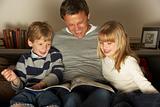 Father And Two Children Reading