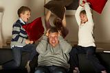 Parents And Two Children In Pillow Fight