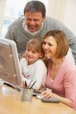 Couple And Daughter Using Computer