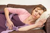Woman Unwell And Lying On Sofa