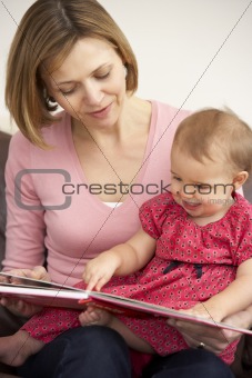 Mother And Baby Daughter Reading Book