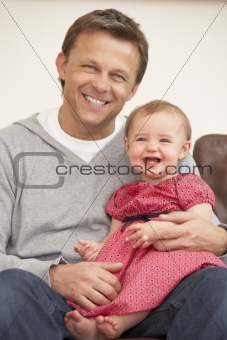 Father And Baby Daughter On Sofa