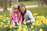 Father And Daughter In Daffodils