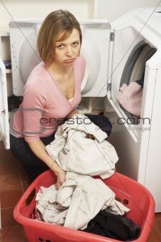 Unhappy Woman Doing Laundry