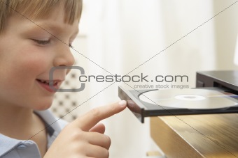 Young Boy Closing DVD Player With Finger