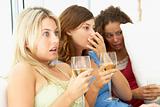 Female Friends Watching A Scary Movie Together