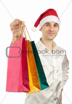 Young men in christmas red hat with paper presents bags