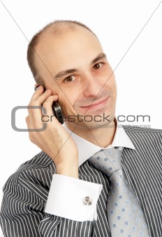 Closeup portrait of a happy young guy speaking on cellphone