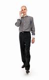 happy businessman talking on mobile phone while walking