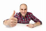 Happy casual young man showing thumb up and smiling