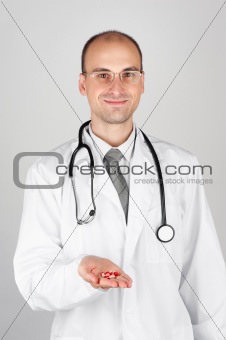 Young doctor offering pill
