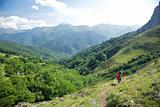 trekking woman down valley in Picos de Europa
