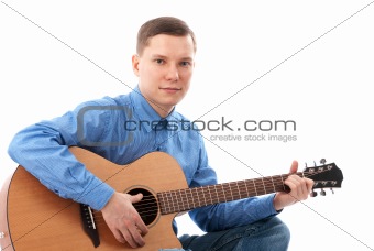 Young man playing an acoustic guitar