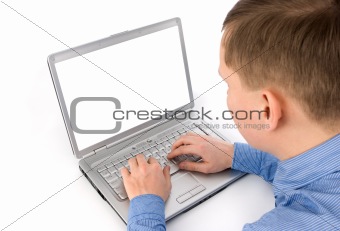 Rear view of a young man working of a laptop