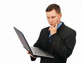 Businessman thinking over his laptop computer