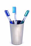 three toothbrushes in a steel cup
