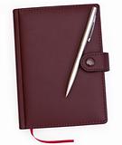 brown red leather notebook with pen