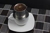 Vietnamese coffee on traditional mat