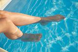 two woman feet in blue pool