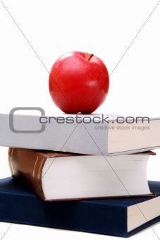 Stack of books and apple.