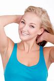 portrait of a young blond woman in blue top smiling - isolated on white