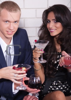 Couple on date in bar or night club enjoying wine