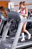 Woman on running machine in gym