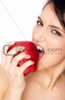 Female biting red apple