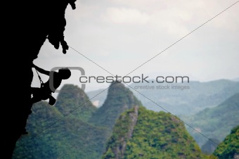 Climbing a steep rocky cliff