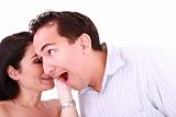 girl tells something into surprised guy's ear isolated on white 