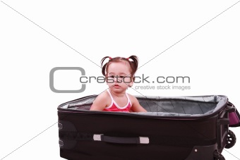 little girl sitting in suitcase 