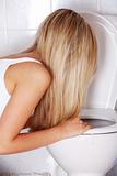 Young blond teen woman vomiting