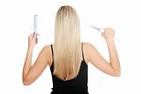 Young blond woman and hairdresser's tools 