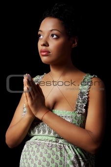 Young pregnant woman praying