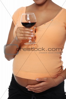 Pregnant woman holding glass full of alcohol
