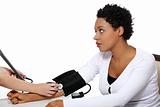 Doctor checking blood pressure of pregnant woman.