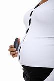 Pregnant woman holding a cellphone against her belly.
