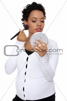 Pregnant woman doing a make up.