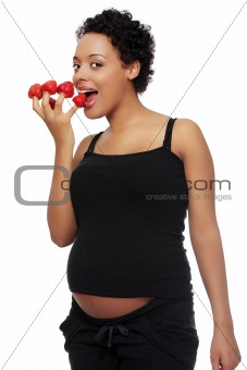 Pregnant woman eating strawberries