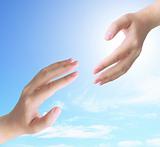 two hand touch isolated on blue sky