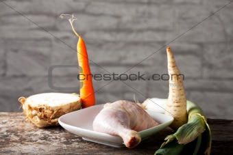 raw chicken leg and vegetables 
