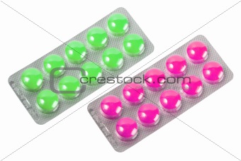 Two metallic blister with purple and green pills