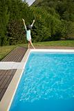 woman jumping on pool corner