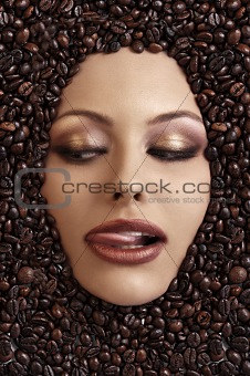 close up portrait of a girl's face immersed in coffee beans