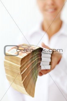 Woman with a stack of euro banknotes