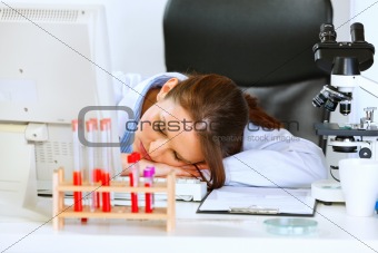 Doctor woman sleeping on office table
