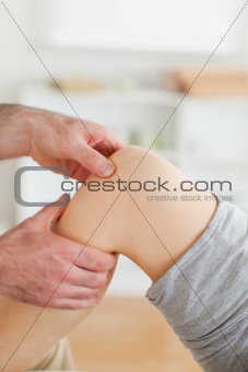 Guy massaging a woman's knee