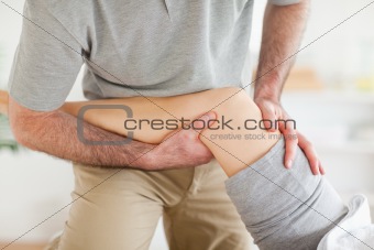 Chiropractor massaging a woman's knee
