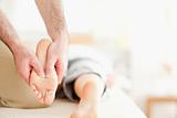 Male masseur massaging a woman's feet