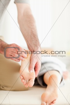 Man massaging a woman's feet